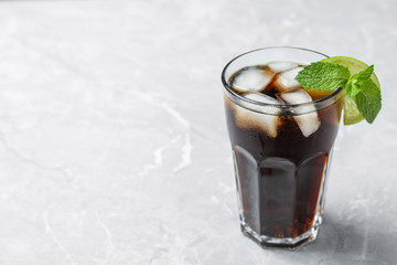 Glass of tasty refreshing cocktail on marble table. Space for text
