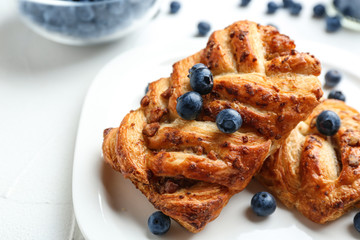 Fresh delicious puff pastry with sweet berries served on light table, closeup