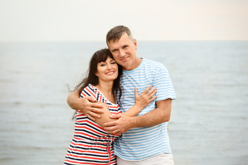 Happy mature couple spending time together on sea beach