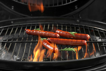 New modern barbecue grill with tasty sausages, closeup