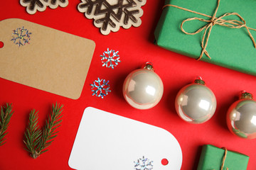 Fototapeta na wymiar Flat lay composition with Christmas decor on red background