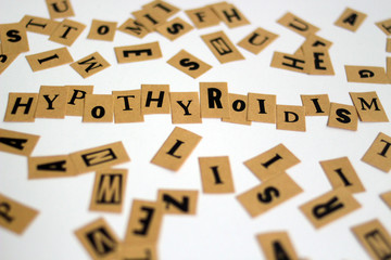 word HYPOTHYROIDISM spelled out on a table