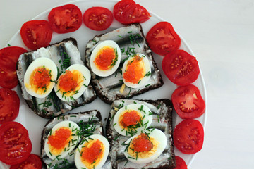 Rye bread sandwich with fish, egg and dill and caviar.Estonian traditional delicacy "kiluvoileib" / "kiluvõileib"