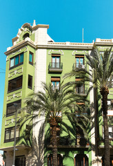 Downtown of Alicante city in Spain at Costa blanca historical building on central Maisonnave avenue green palm trees blue sky
