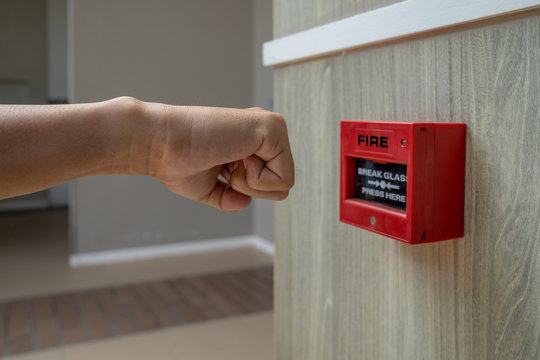 Fire alarm box with human hand action to crush the glass for emergency situation.
