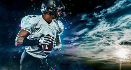 American football sportsman player on stadium running in action. Sport wallpaper with copyspace. © Mike Orlov