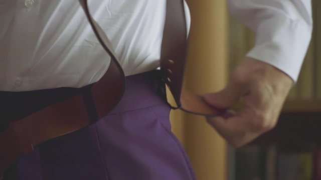 Man putting on a belt