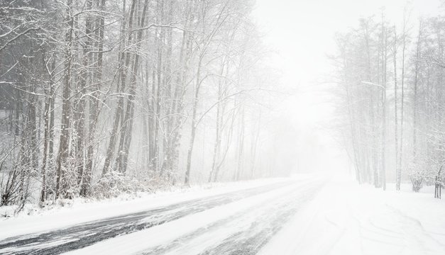 Snowy winter road during blizzard in Latvia