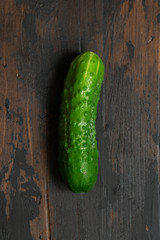 Fresh green cucumber on a old wooden table. Organic food. Top view.