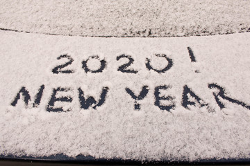 The inscription 2020 on the snow. The inscription on the car. The concept of a New year.