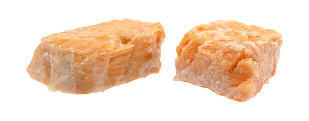 Two canned salmon pieces on a white background