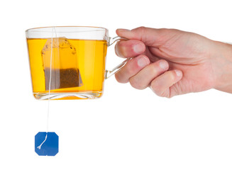Hand holding cup with tea isolated on white background