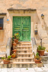 Fototapeta na wymiar old italian house with green door