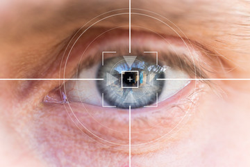 Eye monitoring and treatment in healthcare. Biometric scan of the male eye close-up.