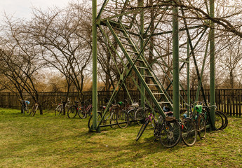 many bicycles are parked in the courtyard of the churchmany bicycles parked in the courtyard of the church on the green grass