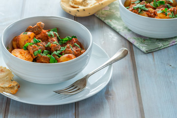 Aloo gosht with naan bread - lamb and potato curry - cuisine popular in Pakistan, Bangladesh and North India