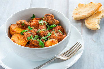 Aloo gosht with naan bread - lamb and potato curry - cuisine popular in Pakistan, Bangladesh and North India