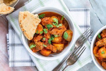 Aloo gosht with naan bread - lamb and potato curry - cuisine popular in Pakistan, Bangladesh and North India