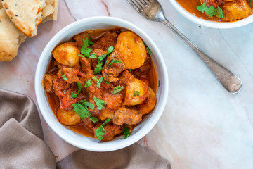 Aloo gosht with naan bread - lamb and potato curry - cuisine popular in Pakistan, Bangladesh and North India - obrazy, fototapety, plakaty