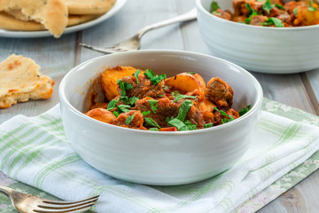 Aloo gosht with naan bread - lamb and potato curry - cuisine popular in Pakistan, Bangladesh and North India