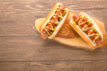 Hot dog with grilled sausage  mustard  and ketchup  onions  and greens on Paper background