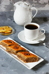 Traditional Azerbaijan holiday Novruz cookies baklava on white plate on the white background with nuts and shakarbura,gogal,sweetbread,tea,lemon,kata,mutaki,flat lay,top view,space for copy