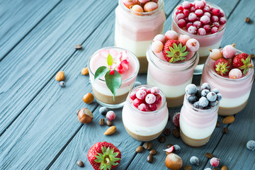 Fototapeta na wymiar panna cotta berry fitness dessert - three layers of milk jelly pudding, coffee, vanilla and berry