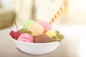 Ice cream scoops in bowl with wafer on white background