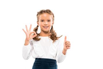 happy kid showing thumb up and ok sign isolated on white