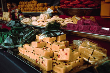 Indian traditional sweets. Asian marketplace. Street food market near Batu caves. Travel to Malaysia. Delicious dessert. India cuisine. Yummy snack