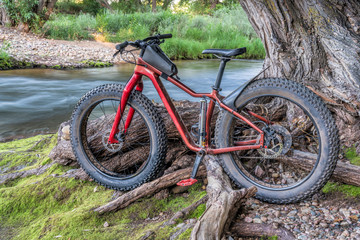 Fototapeta na wymiar fat mountain bike on a river shore