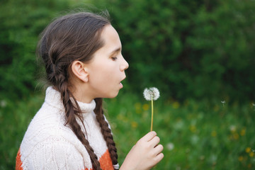 Teen girl and dandelions.