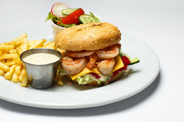 shrimp burger with caviar, vegetable salad and french fries, shrimp sauce