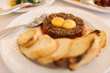 Beef tartare with eggs yolks and toasts. Banquet concept