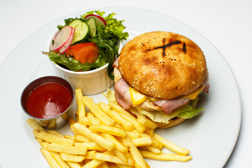 bacon burger with chicken cutlet, french fries, salad