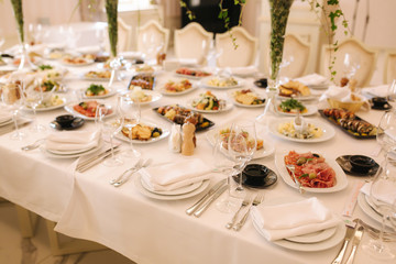 Table with mixed food. Banquet in restaurant, table setting. Differend meals for the guests. Fresh food