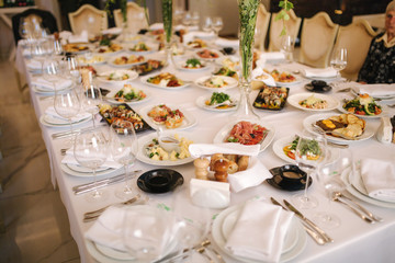 Table with mixed food. Banquet in restaurant, table setting. Differend meals for the guests. Fresh food