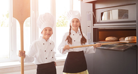 Cheerful kids baking bread
