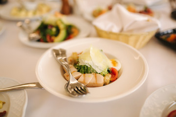 Fresh salad in restaurant on the table. Banquet concapt. Different salads with tomato, arugula, chicken, avocado, parmesan, shrimp