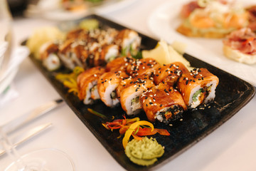 Philadelphia roll sushi with eel fish on the table in the restaurant. Asian food. Banquet concapt