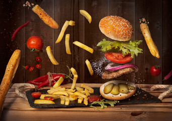 Hamburger and french fries in the interiors of the restaurant. Levitation food. Advertising still life. - 285308476