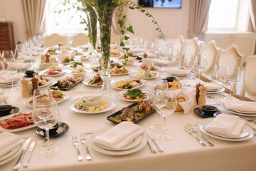 Table with mixed food. Banquet in restaurant, table setting. Differend meals for the guests. Fresh food