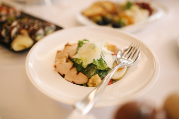 Fresh salad in restaurant on the table. Banquet concapt. Different salads with tomato, arugula, chicken, avocado, parmesan, shrimp