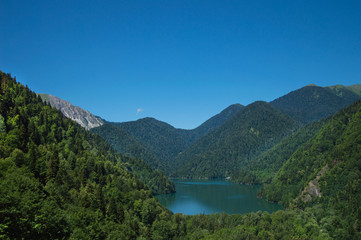 Panoramic view on mountain lake in front of mountain range.