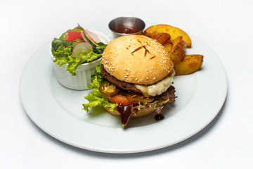 burger with pork and vegetables, salad, french fries, cheese sauce