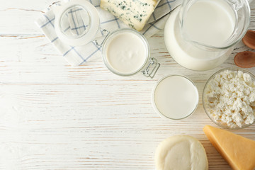 Fototapeta na wymiar Flat lay. Different dairy products on white wooden background, copy space