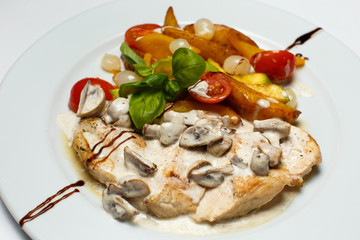 chicken breast in cream sauce with mushrooms and grilled vegetables