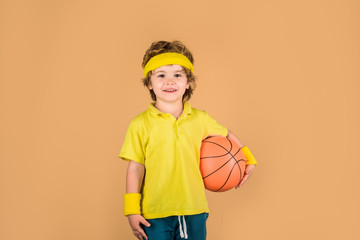 Active lifestyle. Basketball game. Happy boy with basketball ball. Sport boy. Child holds ball. Sport game. Kid activities. Little basketballer. Sports equipment.