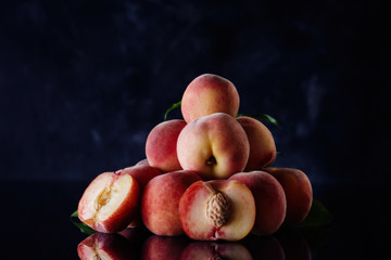 Fresh peaches on dark background