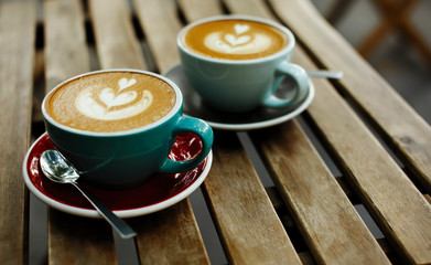 Two cup of coffee on wooden background, breakfast morning concept in cafe
